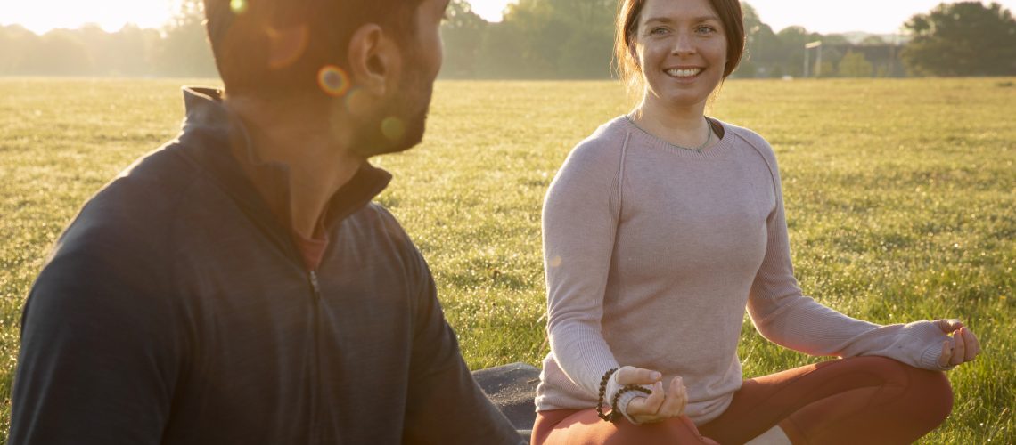 smiley-woman-man-meditating-outdoors-yoga-mat (1)